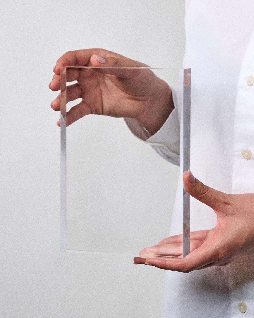 Acrylic award plaque in VITRA A5 format, ready to personalize, held by a model
