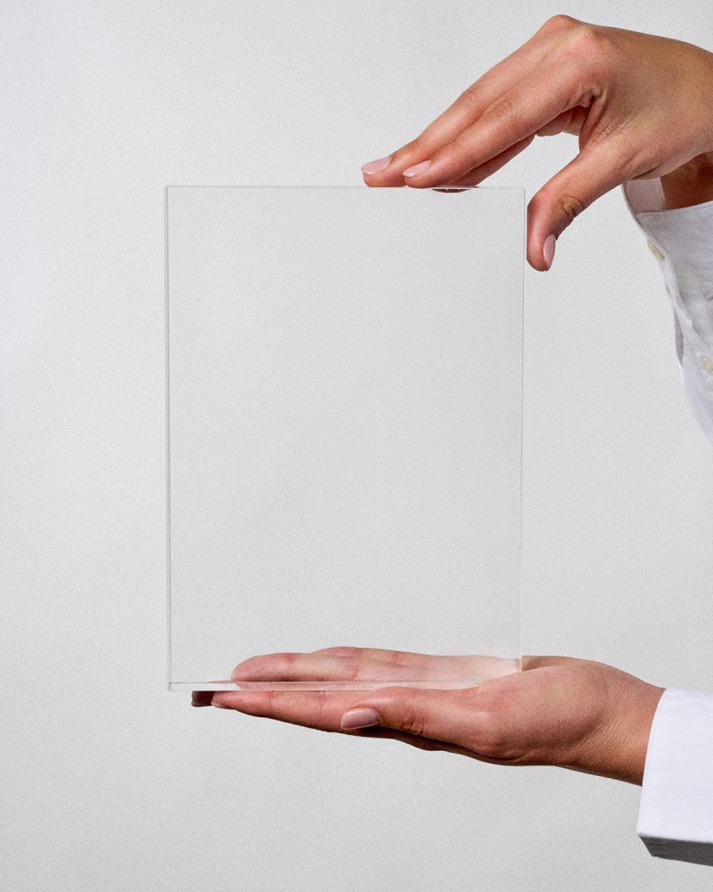 Acrylic award in VITRA A5 plaque format, ready to personalize, held by a model, Sustain Awards