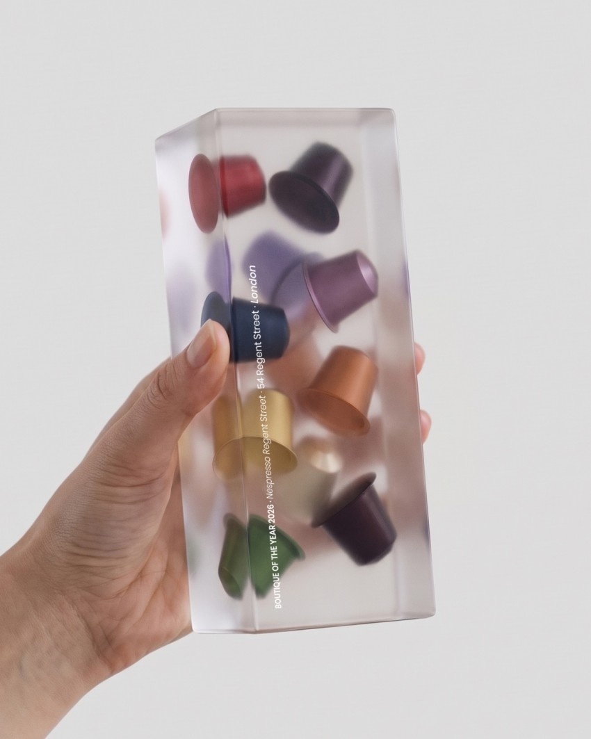 Nespresso Trophy, 2026 - Acrylic Embedment, held in the hand